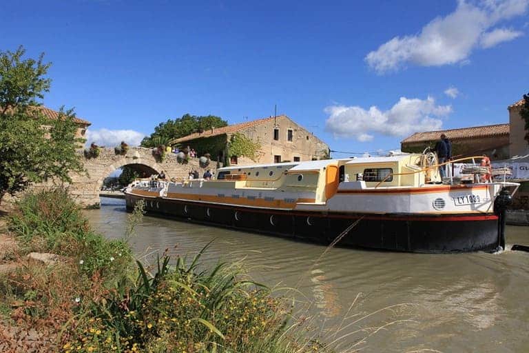 La péniche devant un pont au Somail